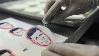 Alan Phillips applies edible paper with caricatures of the presidential candidates to shortbread cookies at Bethel Bakery in Bethel Park on Wednesday.
