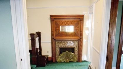 The front hall features a fireplace with mirror.