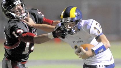 Mt. Lebanon quarterback Tyler Roth runs against Upper St. Clair's J.J. Conn in the first half at Upper St. Clair.