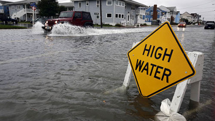 A car goes through high waters as Hurricane Sandy bears down Sunday in Ocean City, Md.