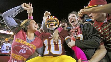 Robert Griffin III celebrates with happy Redskins fans at FedEx Field after a 76-yard touchdown run against Minnesota Oct. 14 == the longest scoring run by an NFL quarterback since Kordell Stewart went 80 yards in 1996.