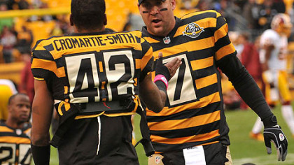 Ben Roethlisberger and Damon Jonnel Cromartie-Smith, both dressed in the team's throwback jerseys, talk during practice before the Steelers' game against the Redskins at Heinz Field.