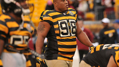 Steelers nose tackle Casey Hampton walks downfield during practice in his retro uniform before the start of the game.