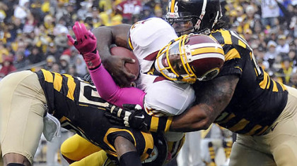 The Steelers' Keenan Lewis and Ziggy Hood take down the Redskins' Robert Griffin III in the second quarter Sunday at Heinz Field.