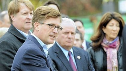 Craig Dunham speaks during the dedication of a new park  at Summerset at Frick Park honoring the memory of  Mark Schneider. With Dunham are County Executive Rich Fitzgerald (left), U.S. Rep. Mike Doyle and Caryn Rubinoff.