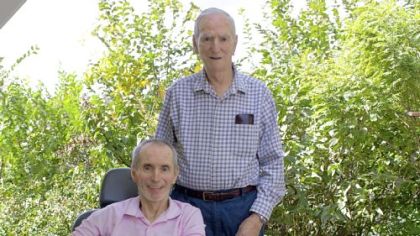 Joseph, standing, and Gary Lynch at their North Versailles home earlier this month.