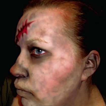 Step Six: Mottled flesh alternative: Apply the foundation as described before. Next apply black or gray (or blue and mauve if you want a marbled bruising effect) with brush all over the exposed skin in a swirling, free-form pattern. Where the lines intersect, dot that area with more eye shadow.