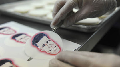 Alan Phillips applies edible paper with caricatures of the presidential candidates to shortbread cookies at Bethel Bakery in Bethel Park.