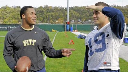 Former Pitt football player Derrick Burns, left, talks to his friend Ethan Brown at practice Tuesday on the South Side. Burns, who was a redshirt freshman fullback, suffered a stroke in the spring. The 20-year-old is now directing his energies toward helping people who survived strokes and other brain injuries.
