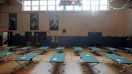 Cots are set up Sunday in the gymnasium at Roxborough High School, designated a Red Cross shelter, in Philadelphia.