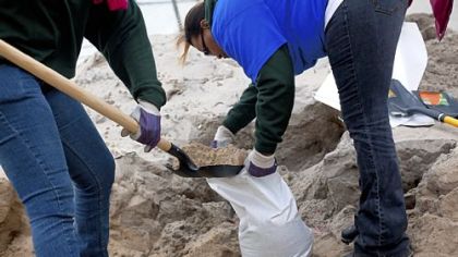 People make sandbags Sunday as Hurricane Sandy approaches in the Rockaway Beach neighborhood of the Queens borough of New York City. New York Mayor Michael Bloomberg announced a mandatory evacuation of low-lying coastal areas of the city.