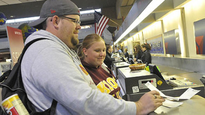 Brian and Lauren Brooks, newlyweds from Minneapolis, book a flight to get home following a drive to Pittsburgh International Airport from New York City after their honeymoon return flight was cancelled October 29, 2012 because of the oncoming hurricane.