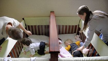Ryan and Summer Carroll wake up their twins, Jay and Lyla, 2, from a nap at their home. Mr. Carroll had to take on two extra jobs after their birth.
