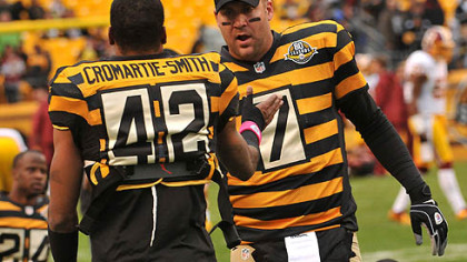 Ben Roethlisberger and Damon Jonnel Cromartie-Smith, both dressed in the team's throwback jerseys, talk during practice before the Steelers' game against the Redskins at Heinz Field.