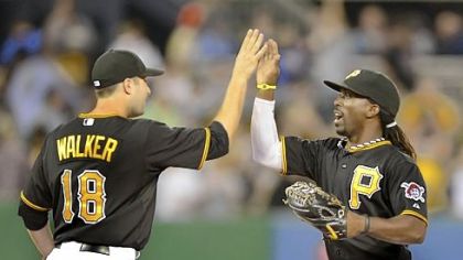 Pirates second baseman Neil Walker celebrates with center fielder Andrew McCutchen after beating the Marlins.
