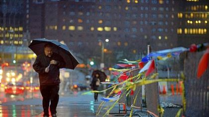 A man walks under an umbrella along Centre Avenue in Uptown on Monday.