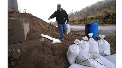 Bob Hillard, who owns a plumbing shop in Millvale, fills sandbags at Riverfront Park in preparation for possible flooding from Hurricane Sandy. He suffered more than $100,000 in damage to his business from Ivan in 2004 and said he's "paranoid and stressed."