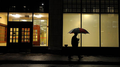 A pedestrian with an umbrella along Smithfield Street early Monday morning in a bit of a calm before the storm.