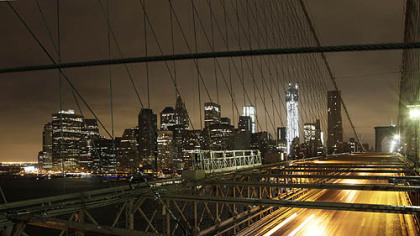 Cars streak across the Brooklyn Bridge as wind and rain from Hurricane Sandy arrive, Monday, Oct. 29, 2012 in New York(AP Photo/)