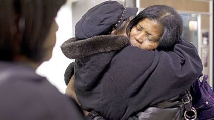 Barbara Hayes, a friend of the family, embraces Elaine Finney, the mother of Conekia Finney, top, before the start of a news conference Wednesday evening at the Ambridge Borough Building.