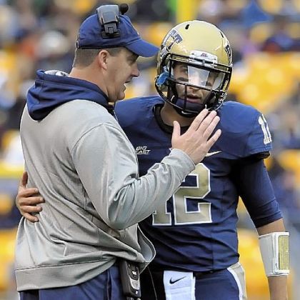 Pitt head coach Paul Chryst talks with quarterback Tino Sunseri near the end of the second quarter against Temple at Heinz Field Saturday.