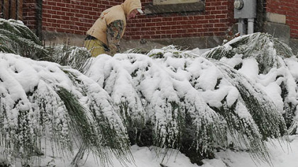 Jon Kimmel clears the walkway of his W. Main Street home in Somerset.