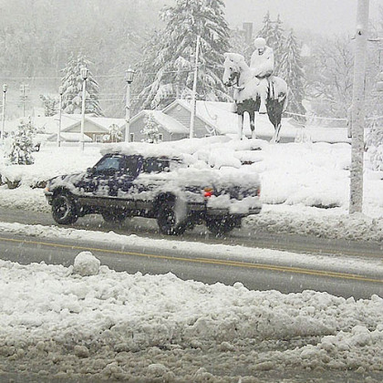 A vehicle travels a freshly plowed road today after Sandy moved through Elkins, W.Va.