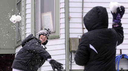 Joshua Bryant, 13 and his sister Dakota Caldwell, 9, have a snowball fight at their front yard in Morgantown today. They moved from San Antonio, Texas, in August and today is their first time playing in the snow.