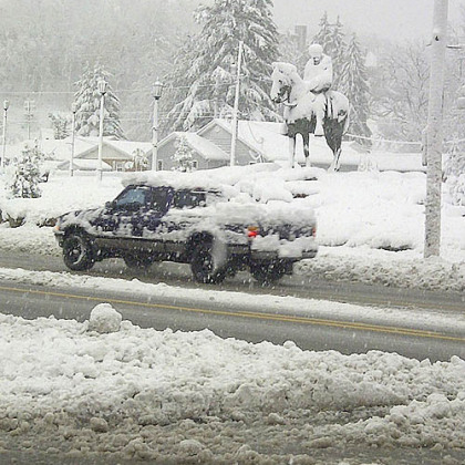 A vehicle travels a freshly plowed road today after Sandy moved through Elkins, W.Va.