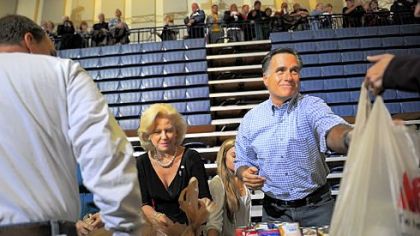 Republican presidential candidate Mitt Romney helps collect and pack donated goods at a storm relief center in Kettering, Ohio, near Dayton.