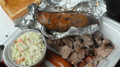 Dinner at Bono's, Clockwise, cole slaw, baked sweet potato, pork, hot sausage.