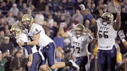 Pitt kicker Conor Lee,left, celebrates with holder Andrew Janocko (4) after kicking the winning field goal in the fourth overtime period against Notre Dame in 2008.