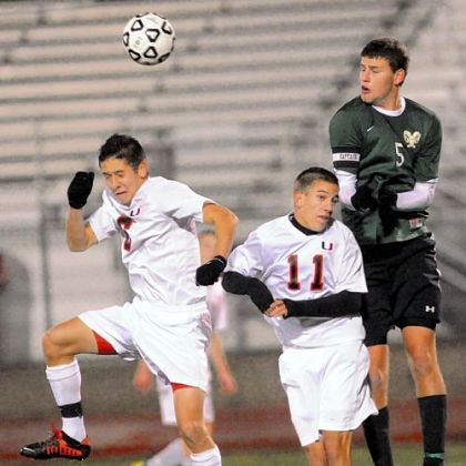Pine-Richland's Patrick Sullivan heads a ball at midfield against Upper Saint Clair's Ethan Dysert, left, and Adam Heil.