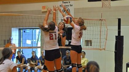 Hopewell's Mackenzie Biggs spikes a shot between Moon's Morgan Malcolm (21) and Katy Peters.