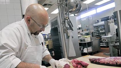 Dennis Denk, chef at Ruth's Chris Steak House at PPG Place, trims and breaks down a whole tenderloin into filet mignon steaks.