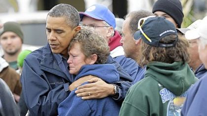 President Barack Obama embraces Donna Vanzant during a tour of a neighborhood effected by superstorm Sandy, in Brigantine, N.J.