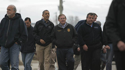President Barack Obama, second from left, Sen. Bob Menendez, D-N.J., center and New Jersey Gov. Chris Christie, second from right, examine damage  in Brigantine, N.J. Sandy, the storm that made landfall Monday, caused multiple fatalities, halted mass transit and cut power to more than 6 million homes and businesses.