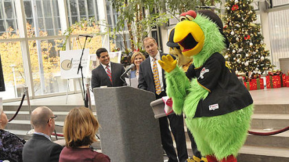 The Pirate Parrot stands by with Steely McBeam as Andy Wisniewski, vice president of Highwoods Properties./PPG Place, center, talks about the ice rink and the planned mascot skate during a press conference today.
