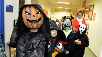 Alex Owczarzak, a third-grader at West View Elementary School in Ross, walks with his class through the hallways for the school's Halloween parade Wednesday.  The rain kept the parade indoors.