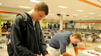 Upper St. Clair seniors Josh Simmons and Alex Bloom mark their ballots today at the school's cafeteria.