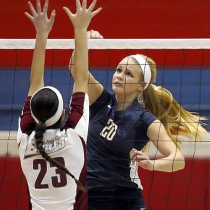 Mt. Lebanon's Megan Riemer spikes the ball against Oakland Catholic's Lauren Slater Thursday night.