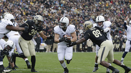 Penn State's Michael Zordich goes in for a 6-yard touchdown run against Purdue's Joe Gilliam (39) and Jalani Phillips (89) during the first half.