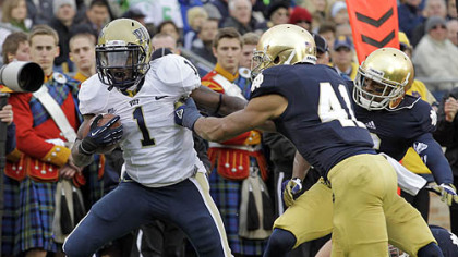 Pitt running back Ray Graham, left, breaks the tackle of Notre Dame safety Matthias Farley to score a touchdown during the first half.