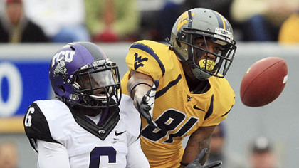 West Virginia wide receiver J.D. Woods catches a touchdown pass in front of TCU safety Elisha Olabode during the first half.