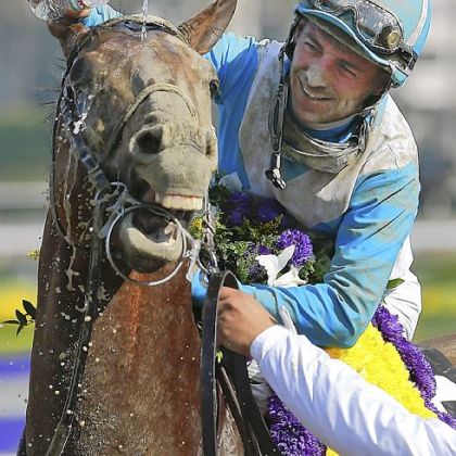 Jockey Aaron Gryder douses Calidoscopio with water after winning the Marathon race at the Breeders' Cup Friday in Arcadia, Calif.