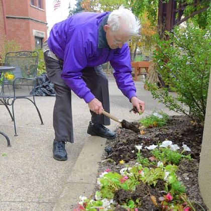Joseph Grindel pulls out annuals at Canterbury Place.