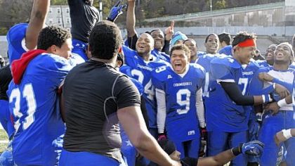 The Perry High School football team celebrates after winning the City League football championship at Cupples Stadium on Saturday.