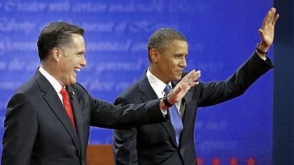 Republican presidential nominee Mitt Romney and President Barack Obama wave to the audience during the first presidential debate at the University of Denver.