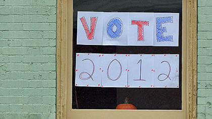 A sign in a window yesterday in Market Square urges voters to cast their ballot.