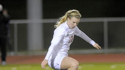 Peters Township's Veronica Latsko hurdles Seneca Valley's Misha Demchuk to gain possession of the ball during title game.